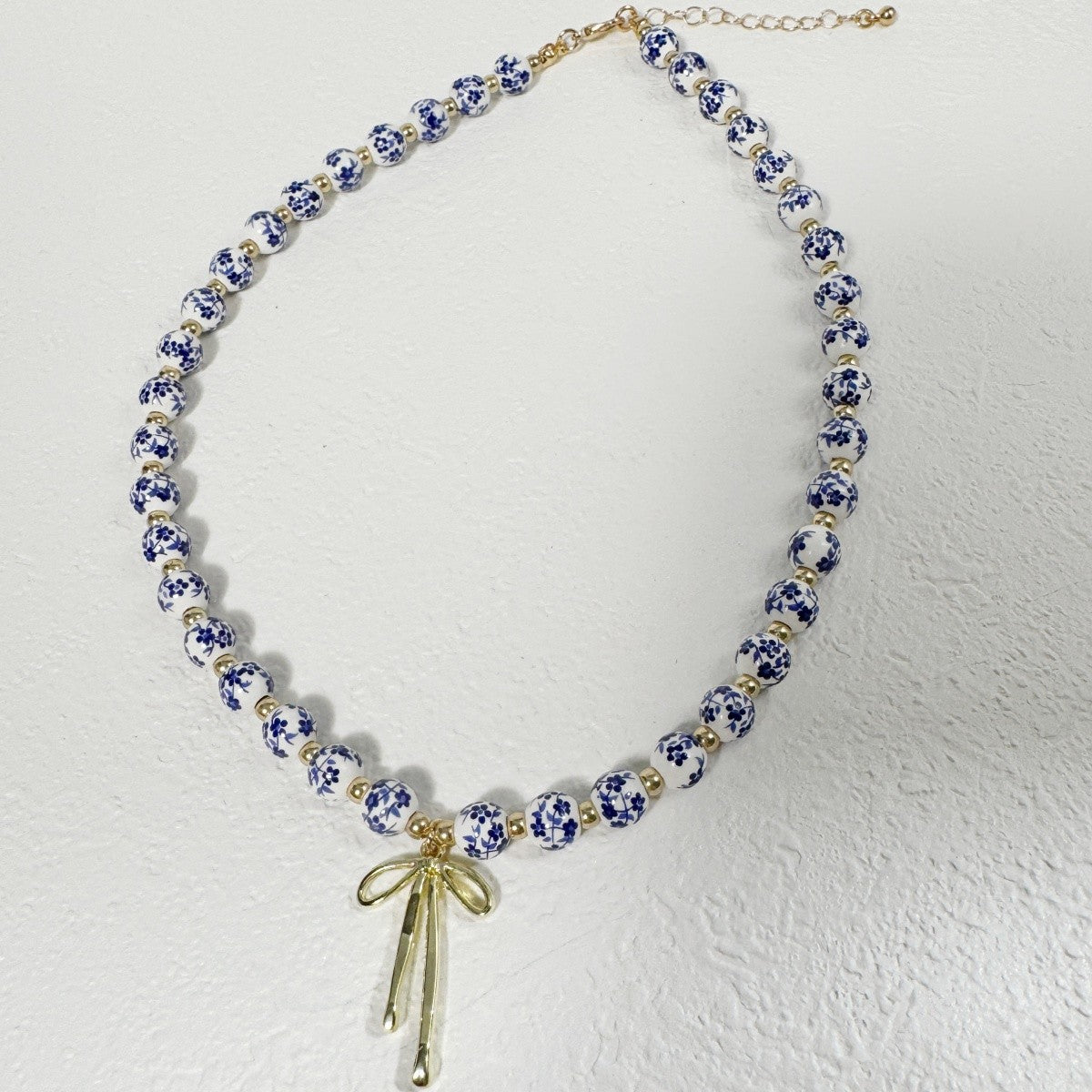 Elegant Blue Floral Bead Bow Necklace