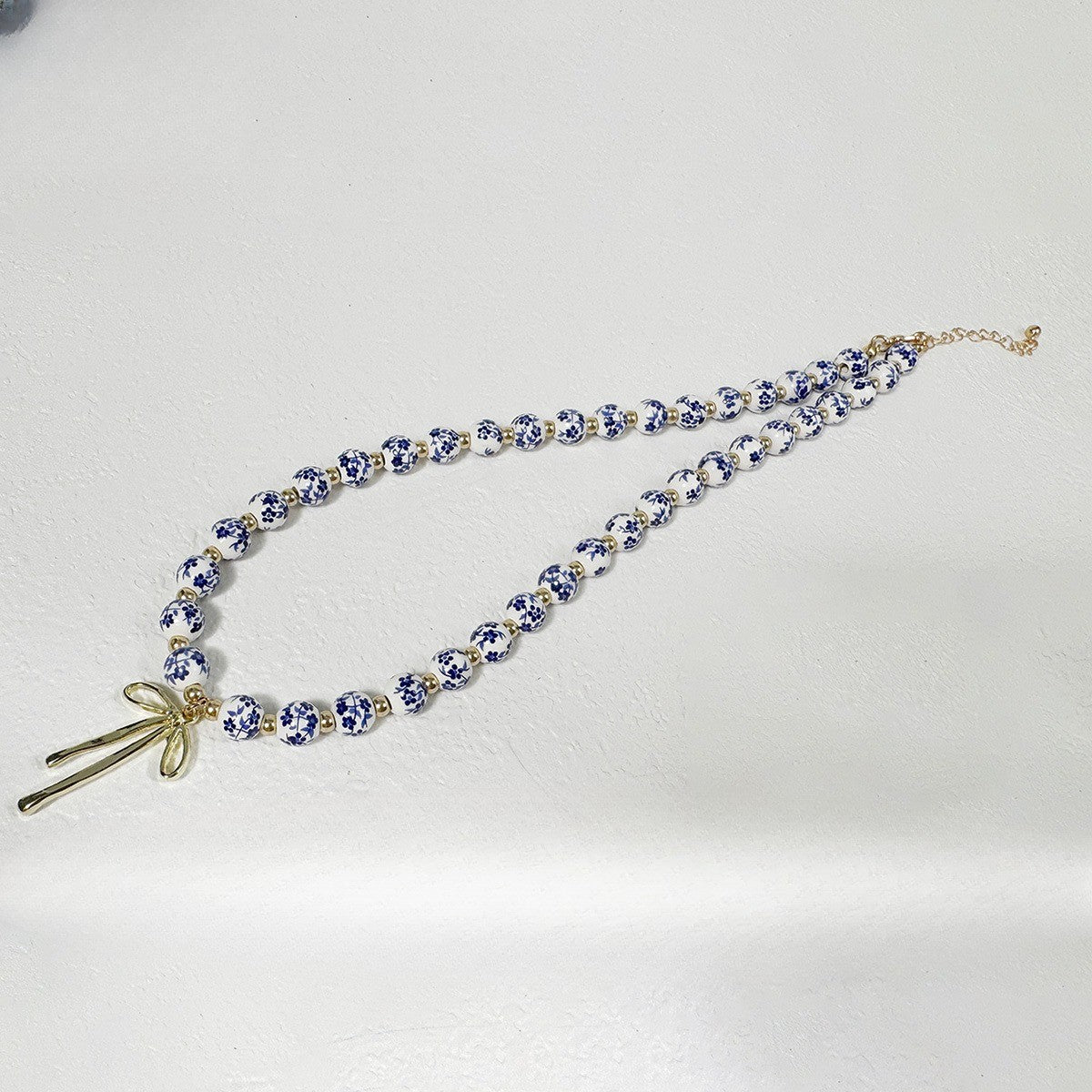 Elegant Blue Floral Bead Bow Necklace